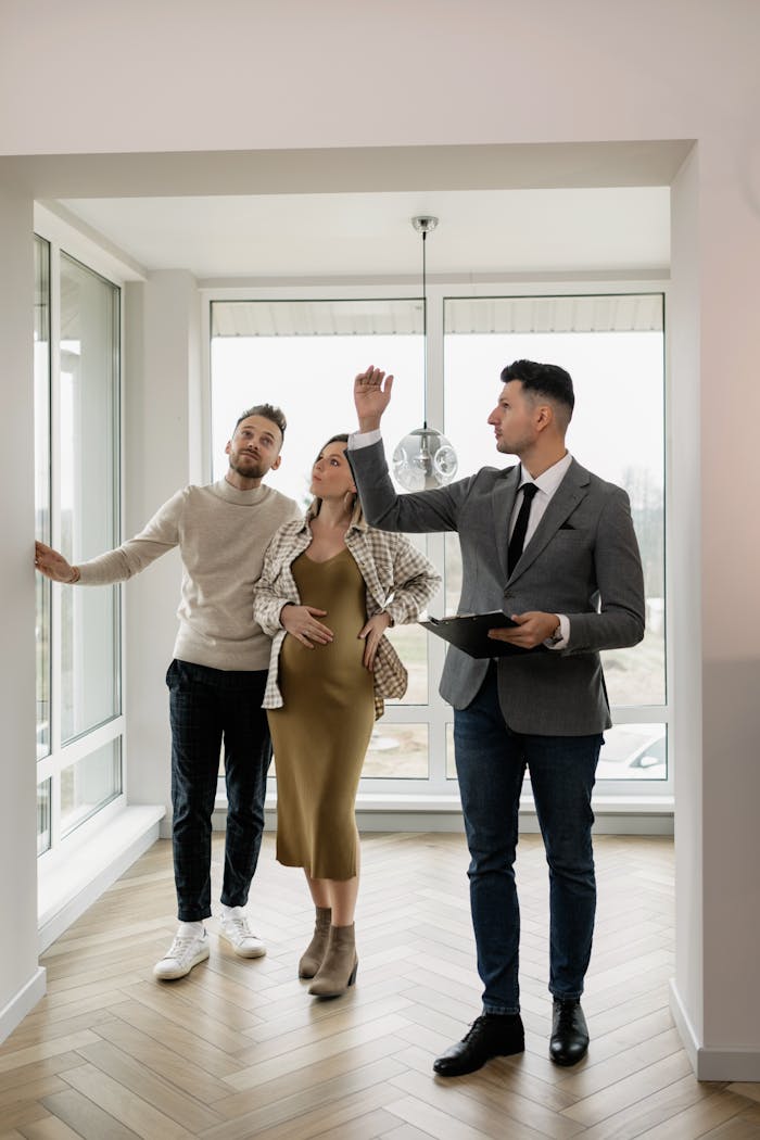 Crafting Captivating Headlines: Your awesome post title goes here A couple tours a modern home with a real estate agent, exploring their potential new living space.