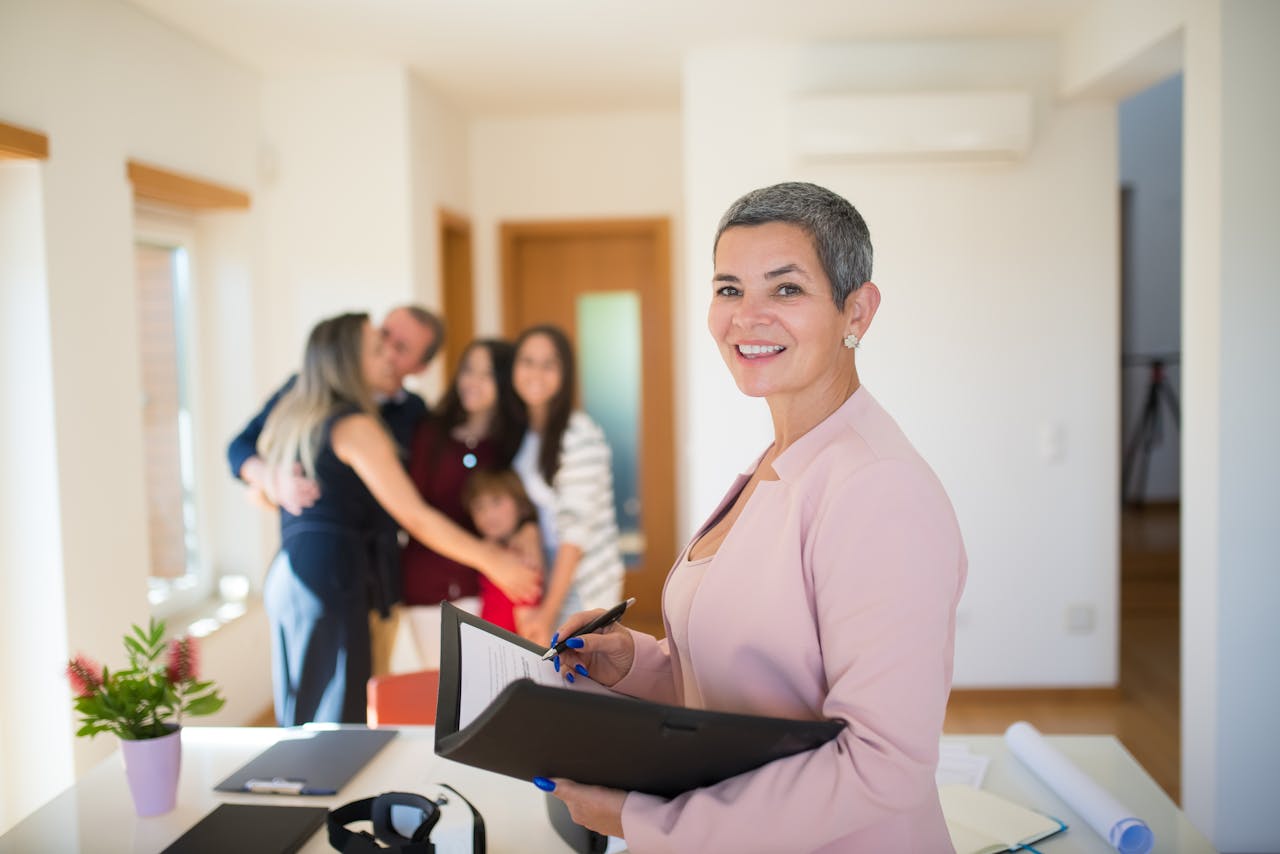 Mastering the First Impression: Your intriguing post title goes here Confident real estate agent presents modern home to elated family, sealing the deal with a smile.